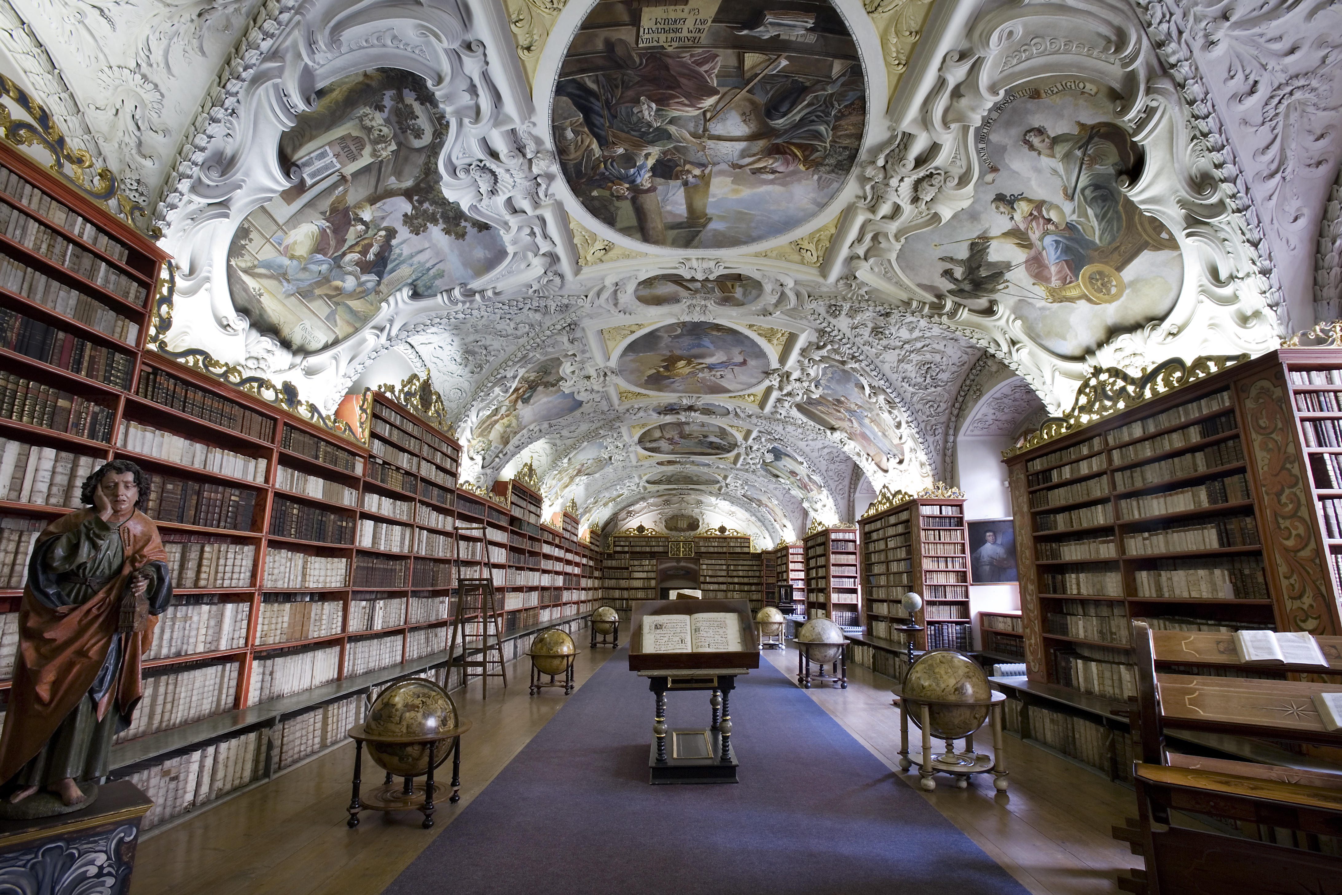 The Strahov Theological Hall in Prague — frescoed ceiling, columns of books, accumulated knowledge.