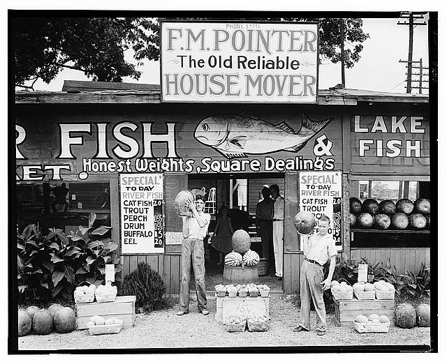 Walker Evans, Roadside stand near Birmingham (1936) — the everyday community the documentary frame held in view.