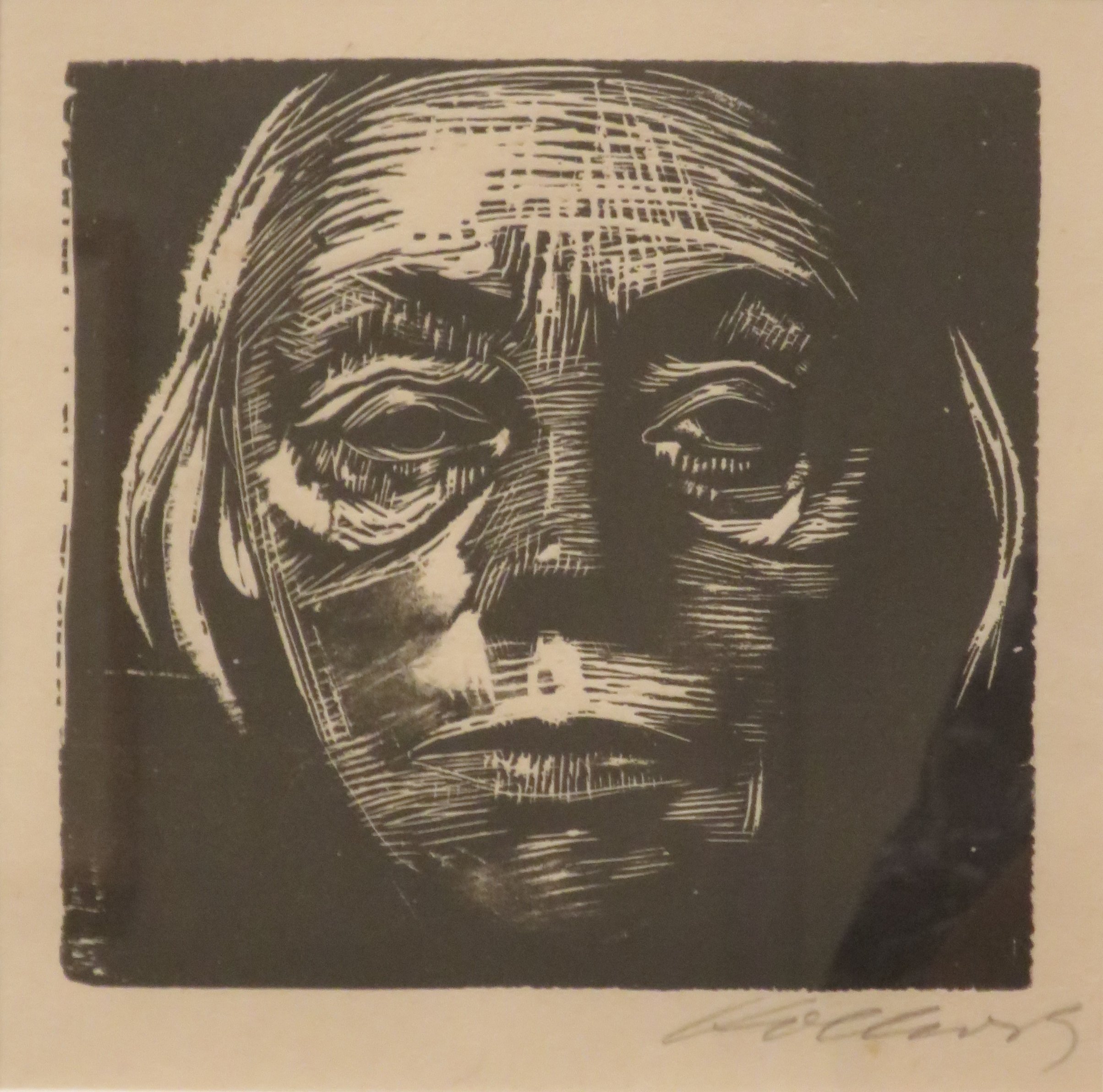 Käthe Kollwitz, Self-Portrait (1923, woodcut, Honolulu Museum of Art) — the artist looks out from the page, head turned slightly, the black ink carrying the weight; one of the nearly fifty self-portraits she made across her working life.