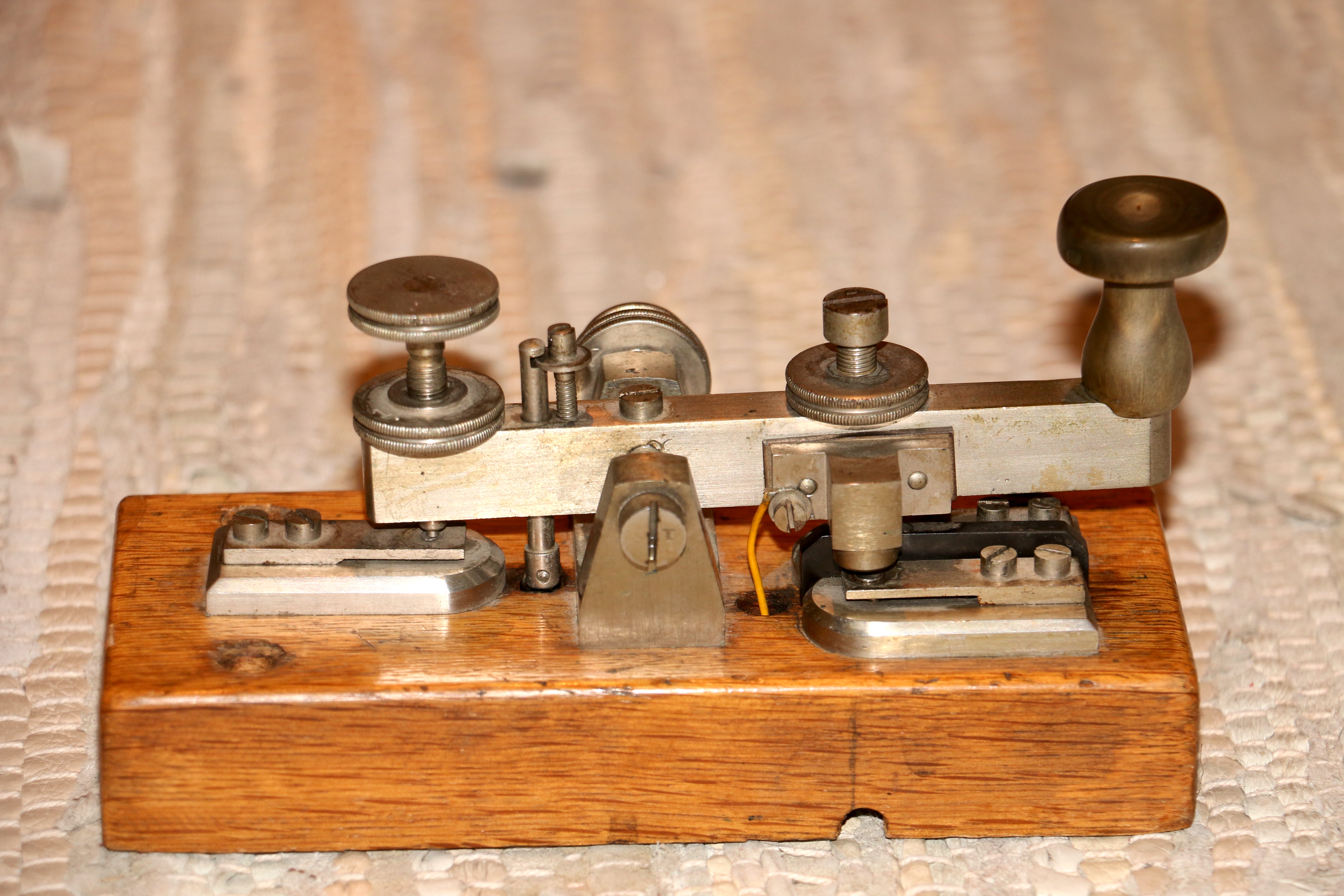A Morse telegraph key (c. 1900) — capture as a single deliberate motion.